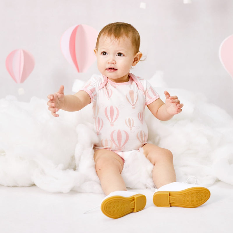 A baby girl dressed Love From Above Baby Romper (Pink) | Oeteo Singapore